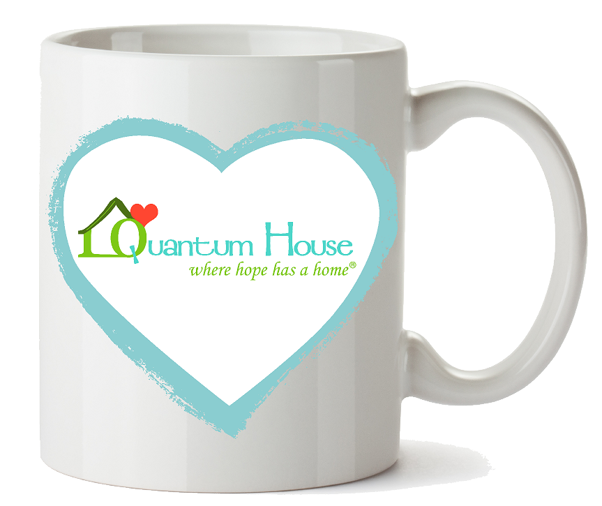 White coffee mug with a blue heart and Quantum House logo promoting support for families in Palm Beach County through artist collaboration